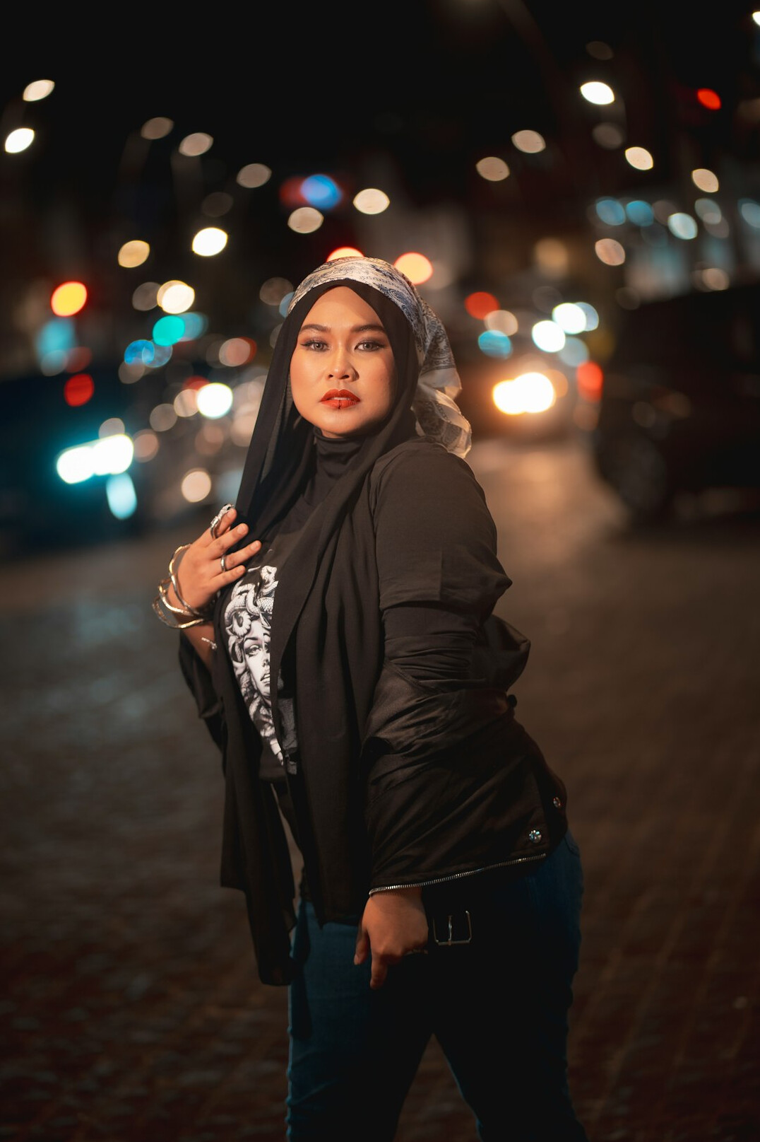 Studio portrait of a Malay Singaporean woman in her 20s wearing a hijab and business attire