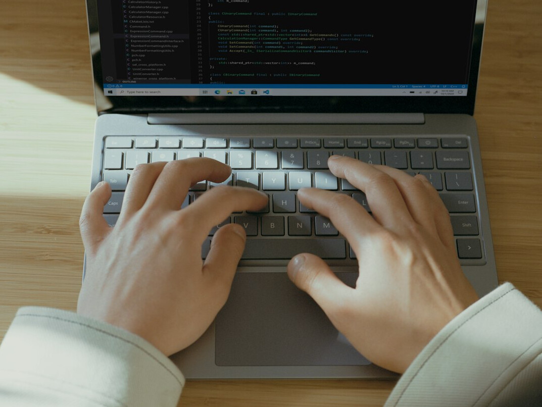 Software developers writing code together at a standing desk