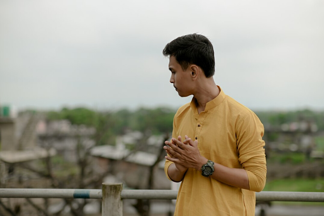 Studio portrait of an Indian Singaporean man in his 30s wearing a casual blazer