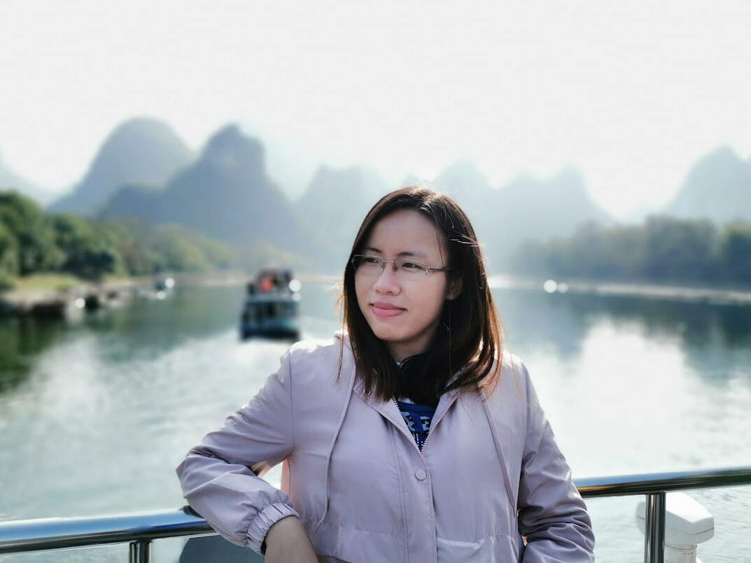 Studio portrait of a Chinese Singaporean woman in her 30s wearing a blazer